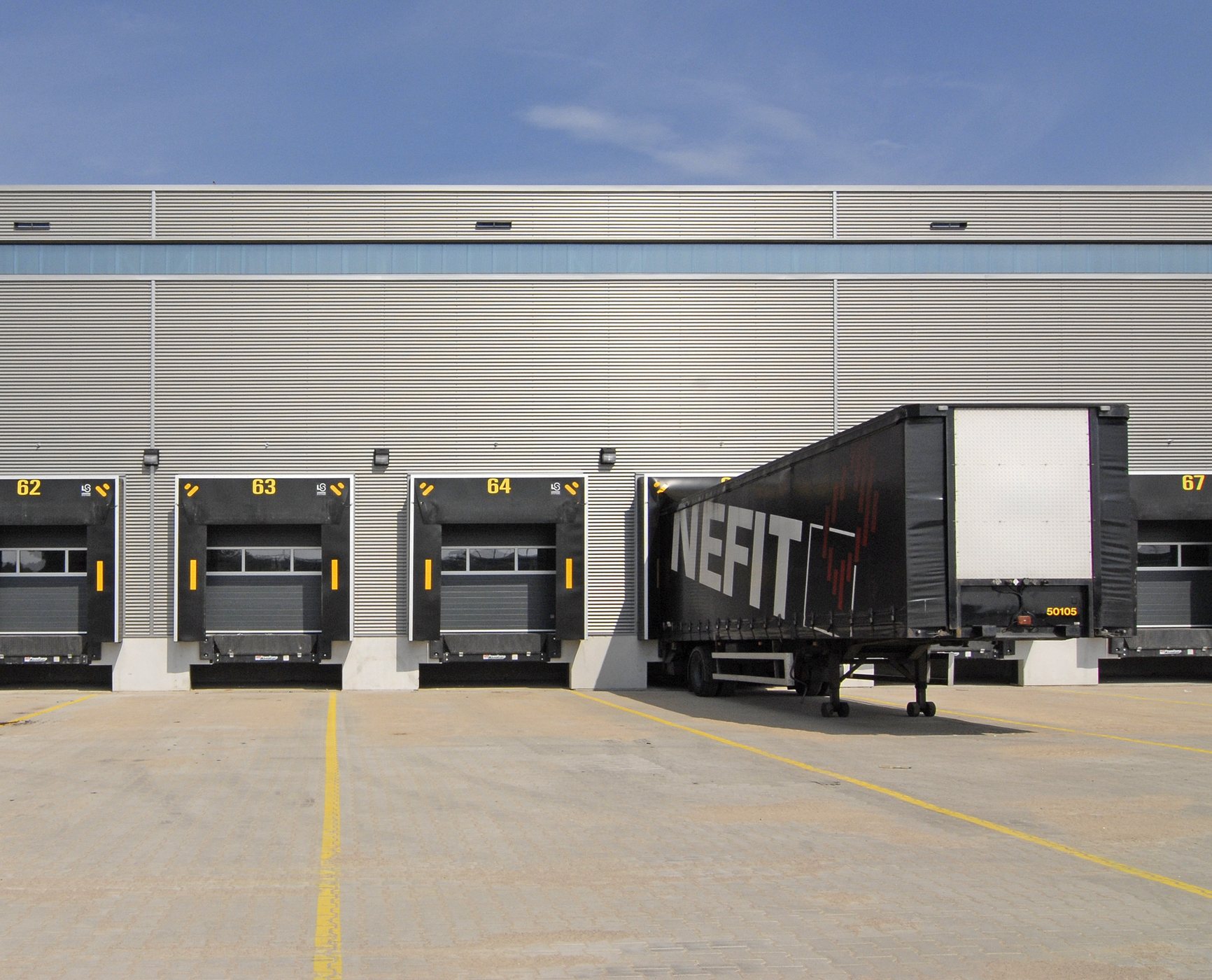Commercial trailer positioned at a modern loading dock