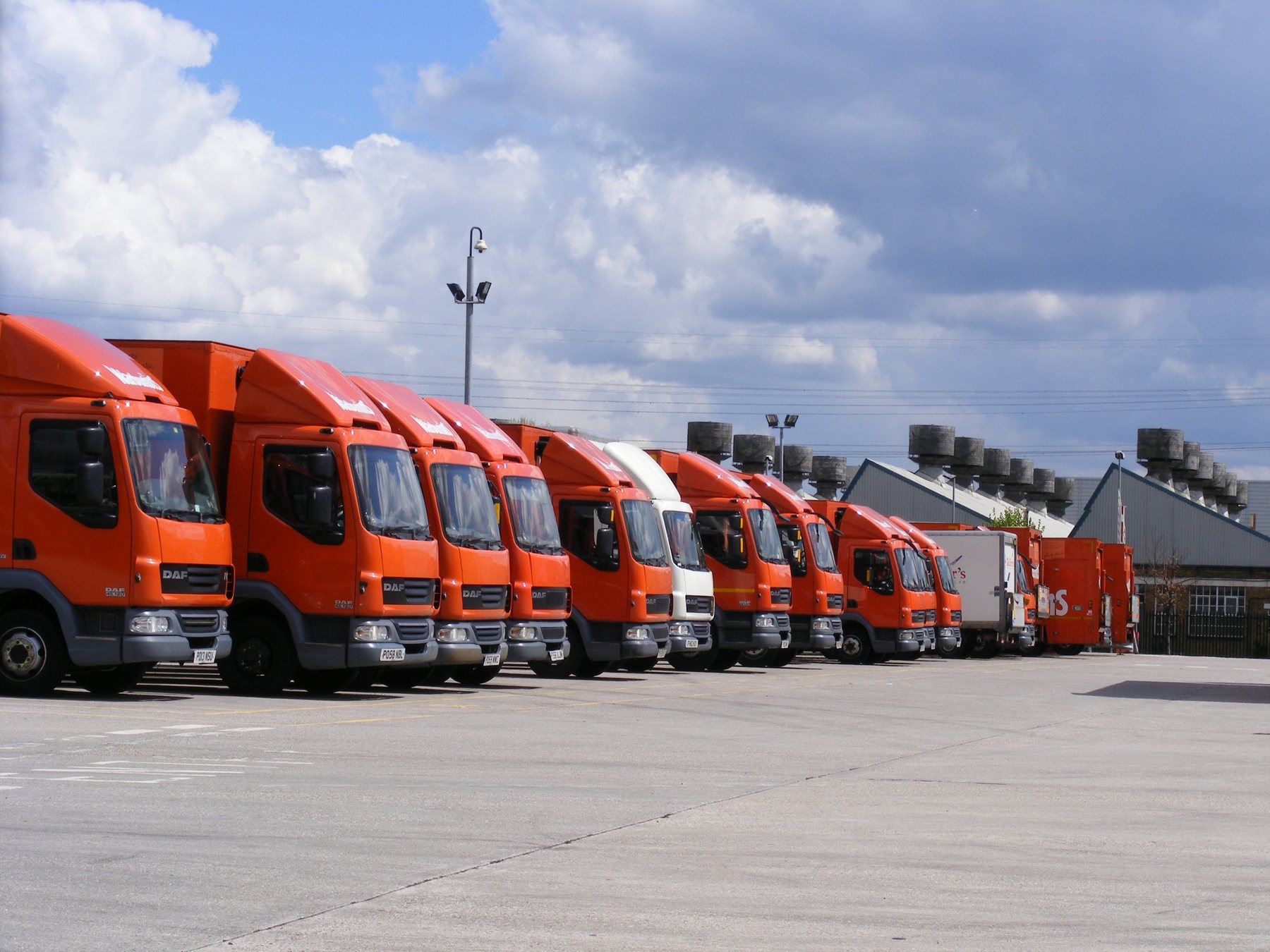 Commercial truck fleet parked at a terminal